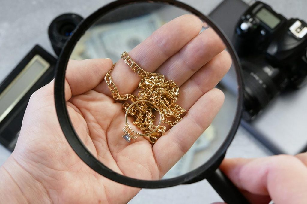 Mitarbeiter des Pfandleihhauses verifiziert Schmuck